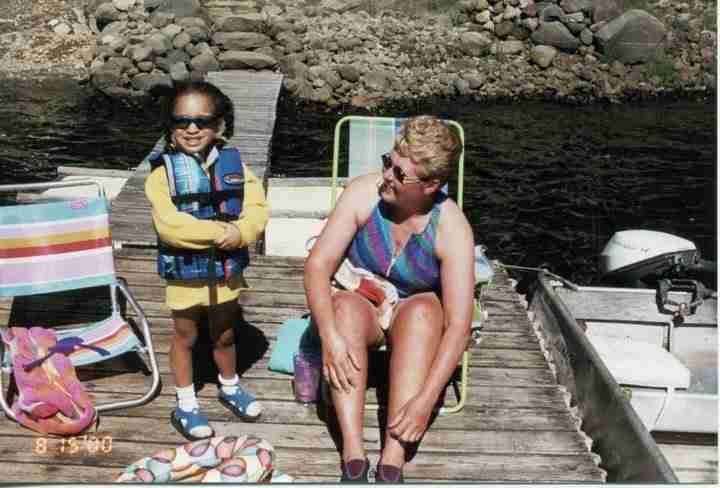 Girl and woman on boat in river