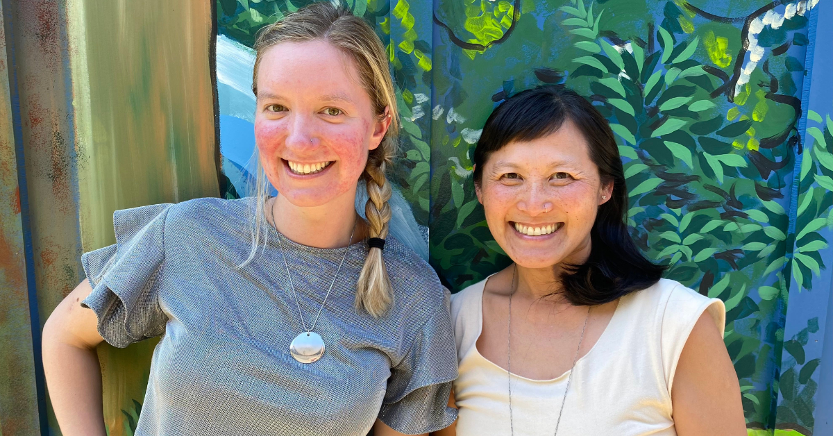 Megan Gleason and Weina Dinata outside the Crag Law Center office mural by Carl Annala