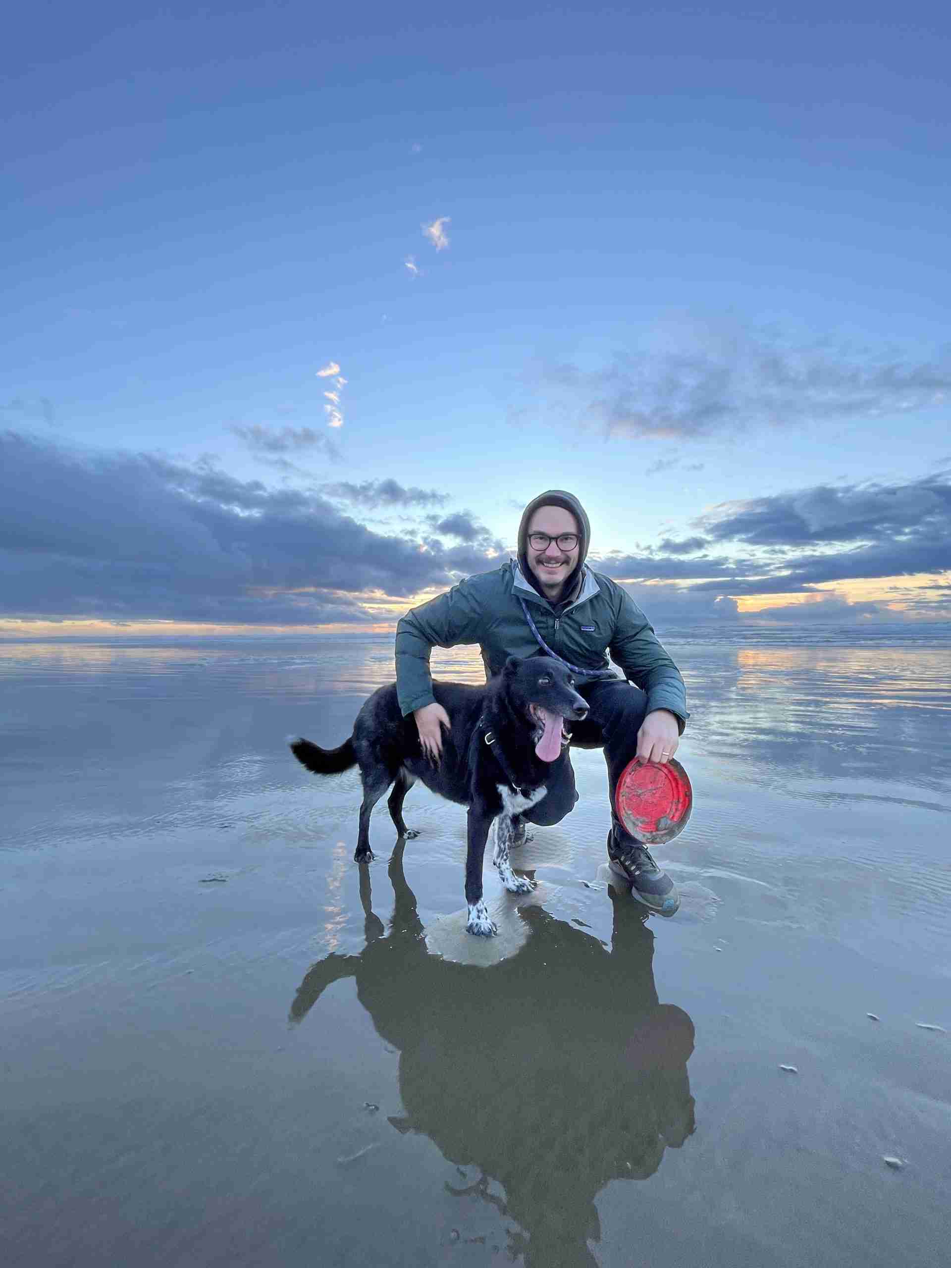 Mike Sargetakis and his dog Wesley enjoying the beach in Newport. Photo by Sarah Martin. 