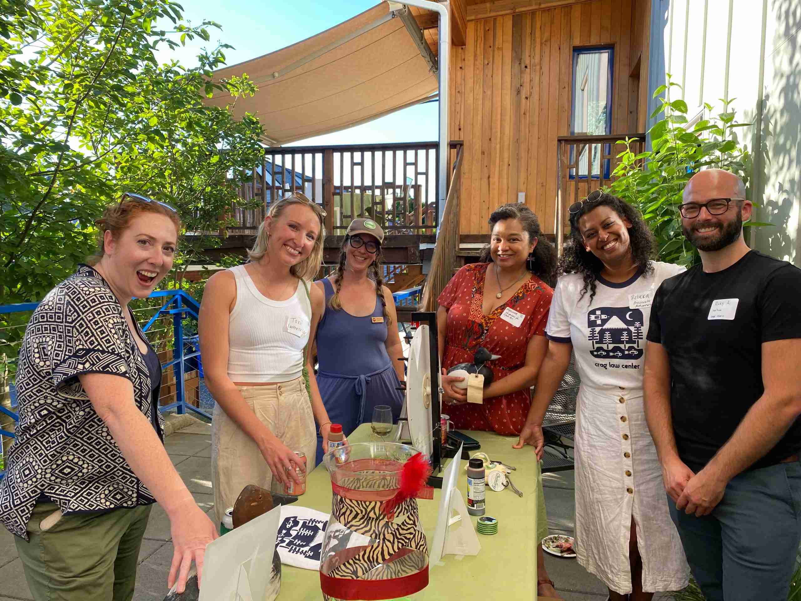 six people smiling at camera in summer party